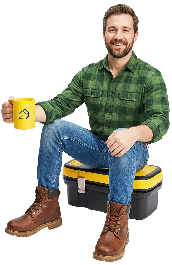 Man sitting on toolbox with a coffee, ready for a chat about Strutos